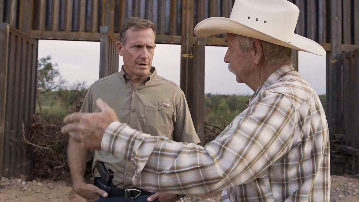 Senator Ted Budd speaks with a man near the US-Mexico border